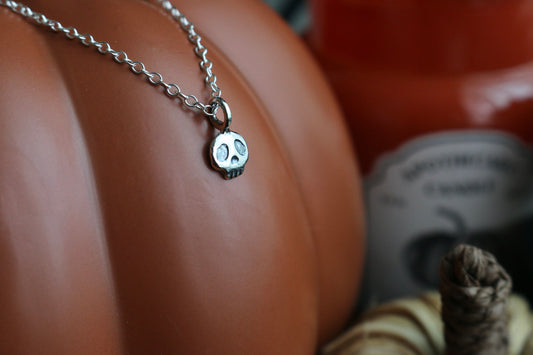 tiny silver skull on a dainty silver chain